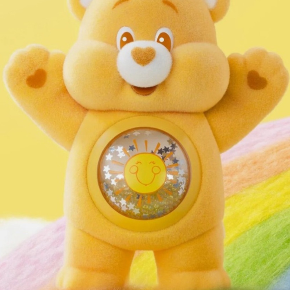 Yellow care bear plastic figurine